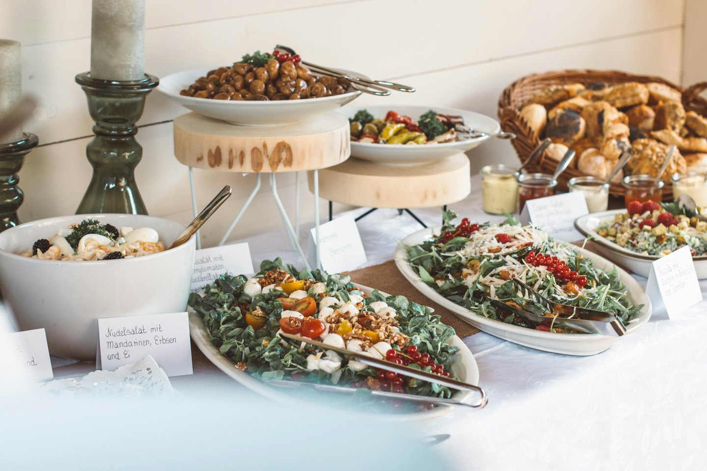 Table de buffet avec salades, petits pains et pâtisseries.